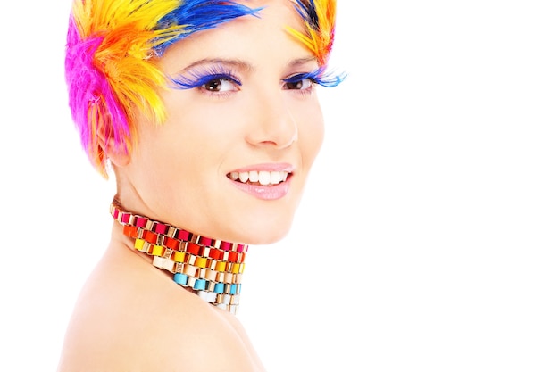 a happy woman in a colourful makeup posing over white background