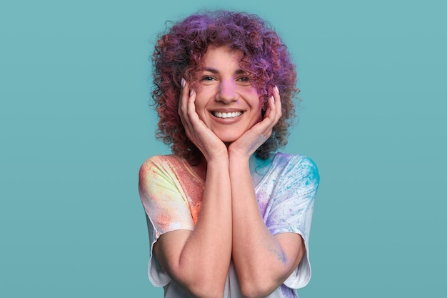 Happy woman covered with colorful paint