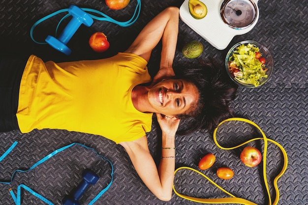 La donna felice fa esercizi con l'elastico in palestra