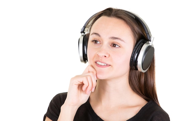 Happy woman dreaming listening music with phone headphone on white