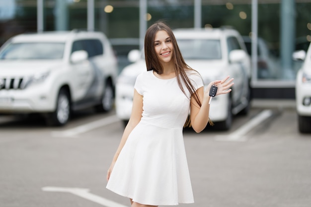 Happy woman driver showing car keys