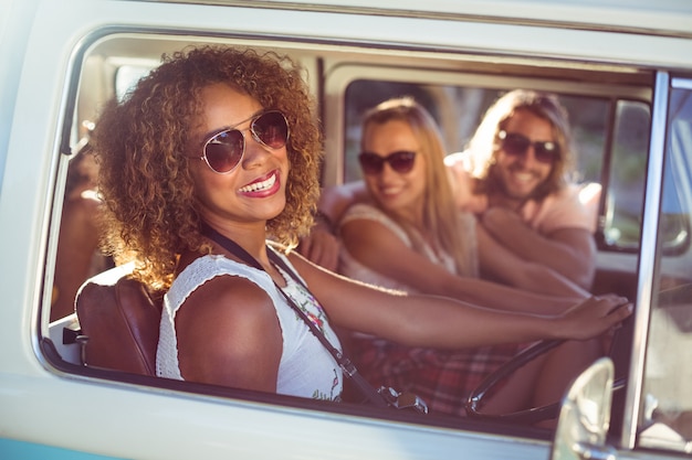 Happy woman driving a campervan