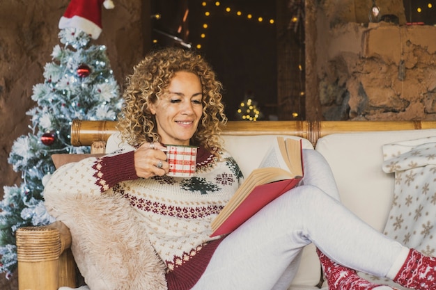 Happy woman enjoy christmas holidays relax at home on the couch