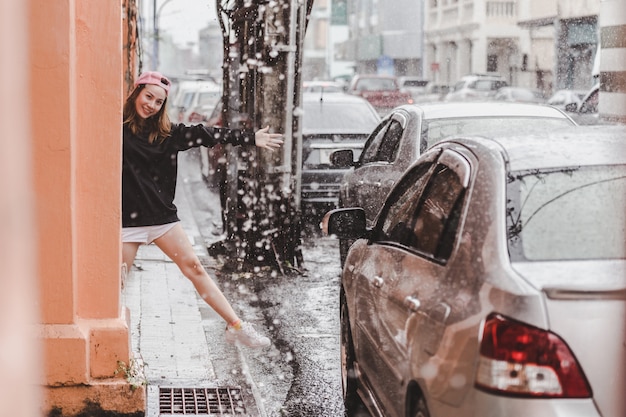 Happy woman enjoying the rain