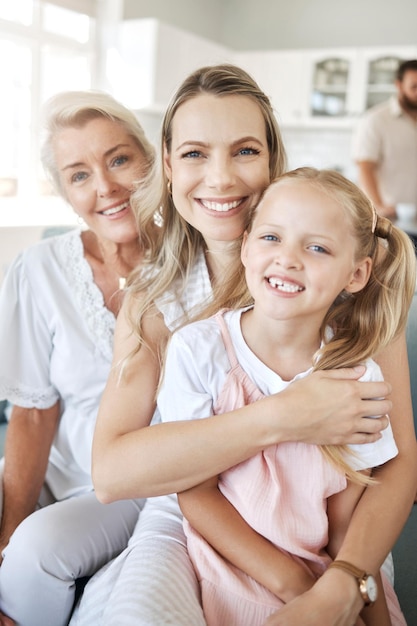 Happy woman in family home with grandmother and girl child portrait together on sofa in Dublin Elderly grandma in lounge with women mama in living room holding daughter and love on mothers day