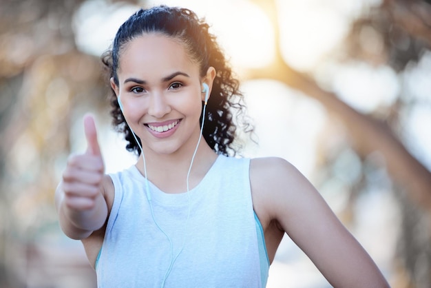 happy woman fitness and portrait smile with thumbs up for winning success or workout in nature fit active or sporty female person or runner smiling with thumb emoji yes sign or like for exercise