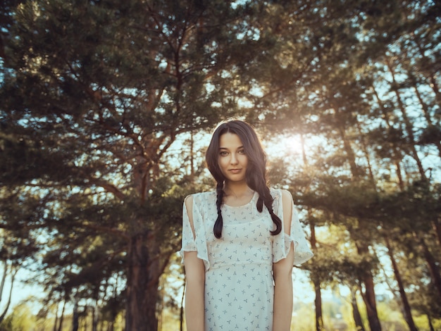 Happy Woman in Forest Enjoying Nature. Girl Standing Outdoors