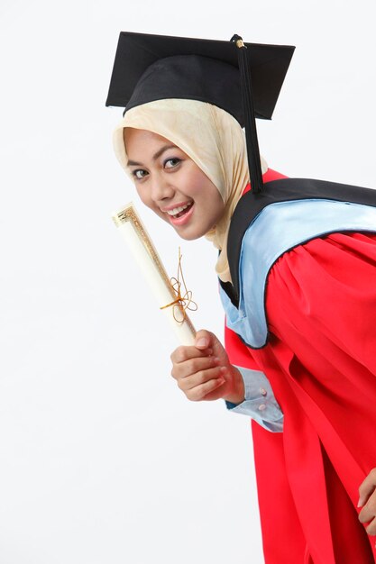 Foto donna felice con l'abito da laurea su uno sfondo bianco