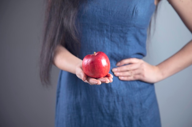 Happy woman hand holding apple and diet