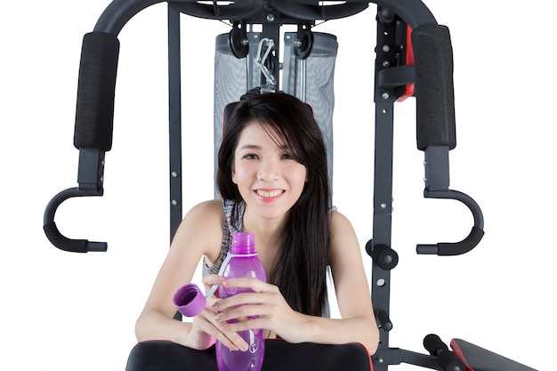 Happy woman holding a bottle on studio