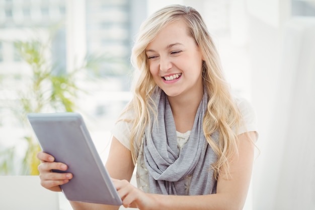 Happy woman holding digital tablet 