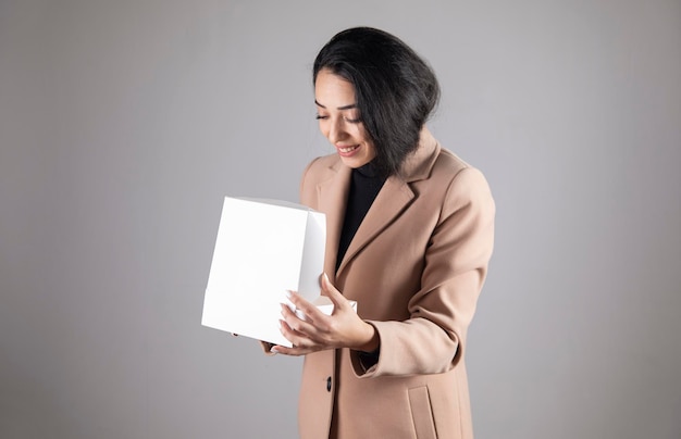 Happy woman holding gift box