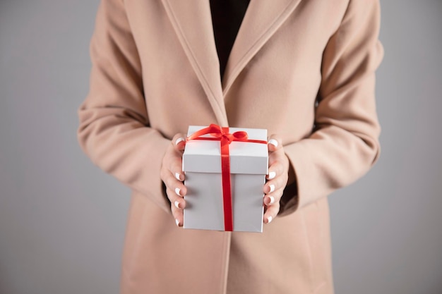 Happy woman holding gift box