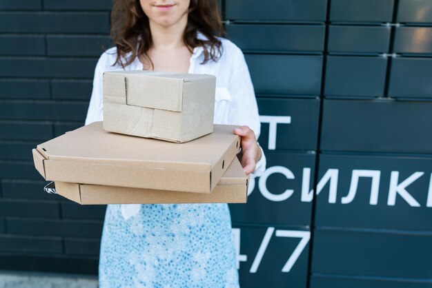 Happy woman holding many different cardboard boxes with online\
order satisfied with fast delivery buying high quality\
products