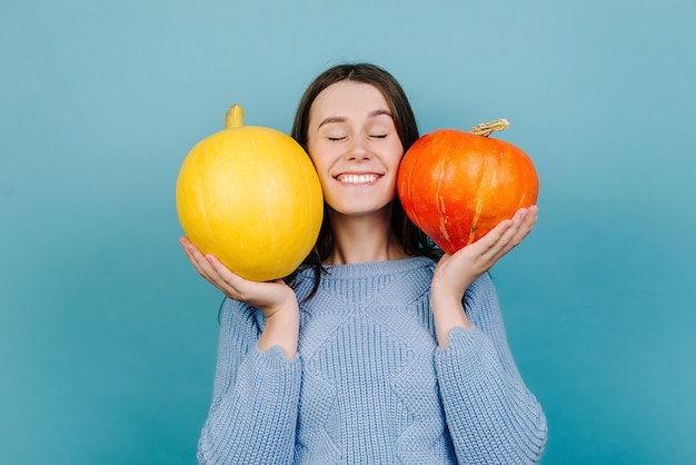 Happy woman holding pumpkins