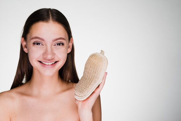 Happy woman holding a sponge in her hands