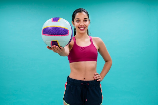 Happy woman holding a volley ball