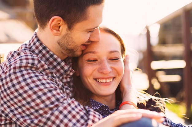 Happy woman hugged tightly by her boyfriend.