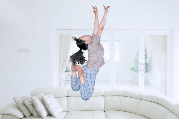 Happy woman jumps in the living room