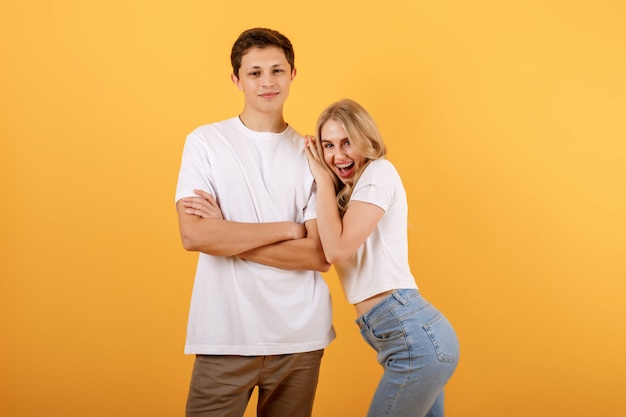 Happy woman leaning on the shoulder of a young man in a white t-shirt