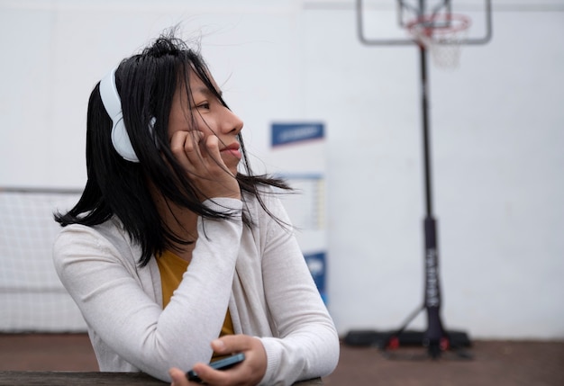 happy woman listening music on the street