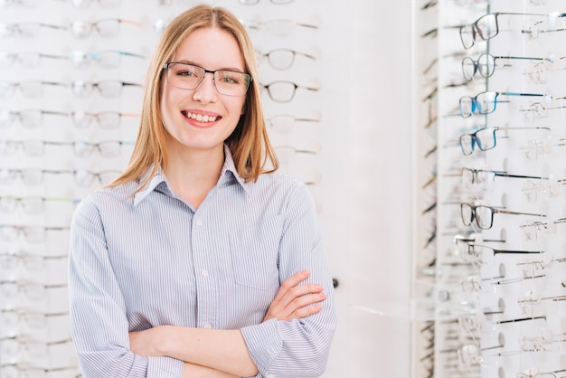 Photo happy woman looking for new glasses at optometrist