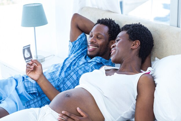 Happy woman looking at ultrasound scan 