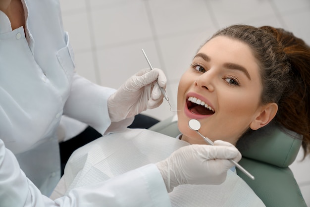 Happy woman lying in dentist chair, posing.