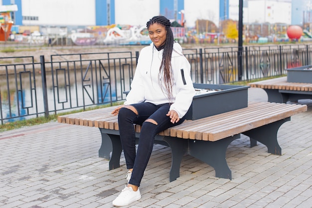 The happy woman in the Park on a bench