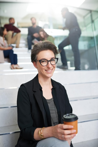 Happy woman portrait and professional in office with coffee for meeting collaboration and discussion in morning Businesswoman glasses and happiness in workplace for international startup company