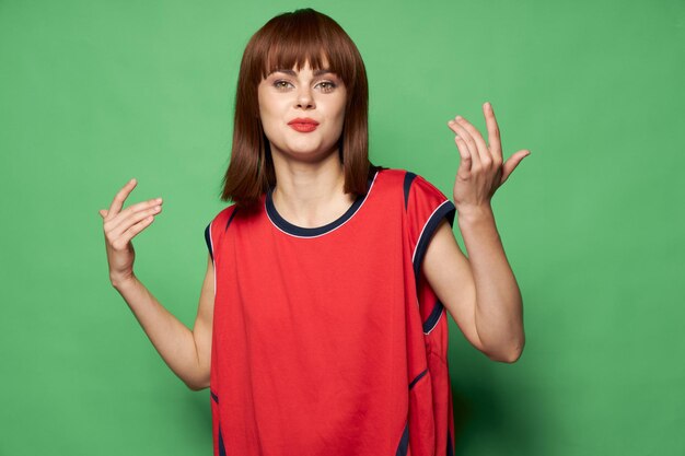 Happy woman in a red shirt gesticulating with her hands