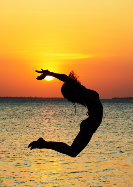 Happy woman relaxes on beach