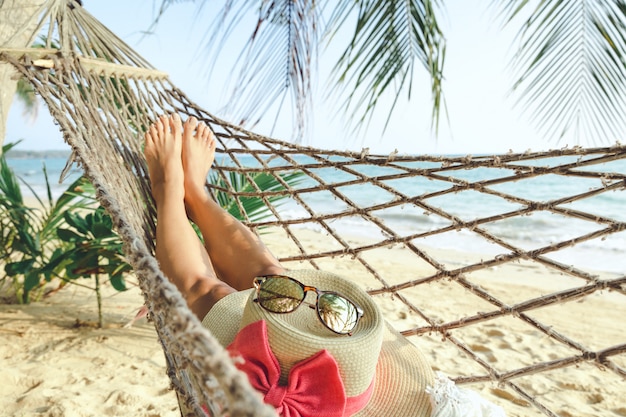 Happy woman relaxing in hammock