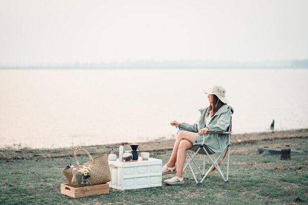 Photo happy woman relaxing in the holiday morning traveling and slow life resting style camping selective and soft focus