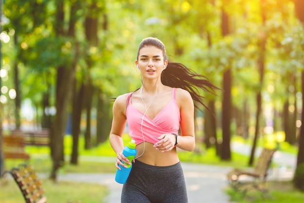 The happy woman running in the park