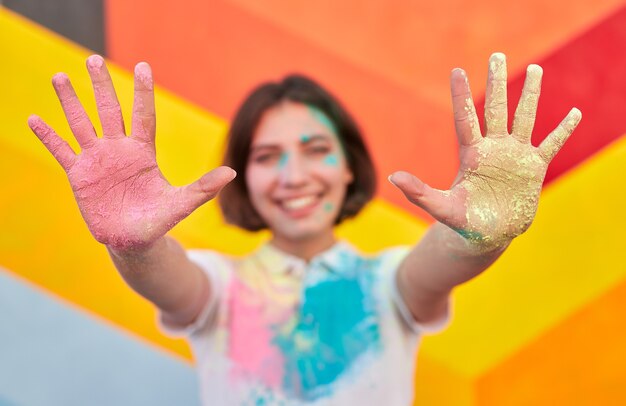 Happy woman showing dirty hands