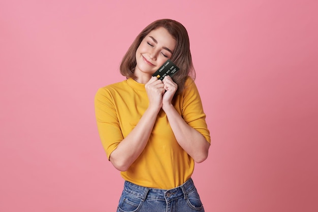 Happy woman showing presenting credit card for making payment or paying online business trust