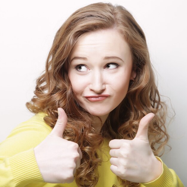 Happy woman showing thumbs up