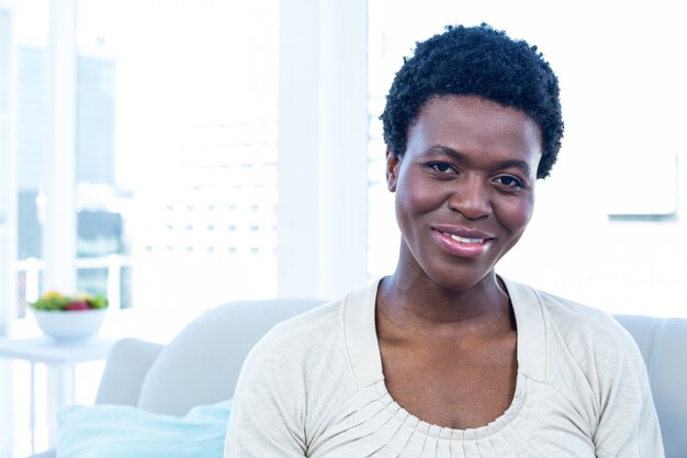 Happy woman sitting in living room