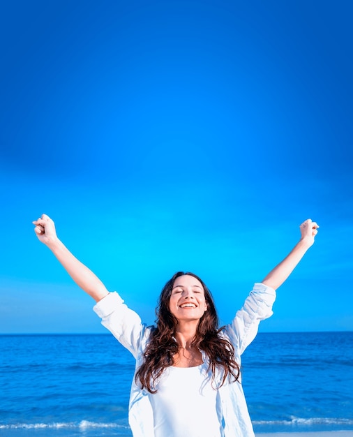 Happy woman smiling at the beach