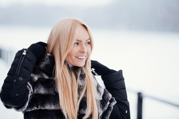 Happy woman smiling on white snow landscape