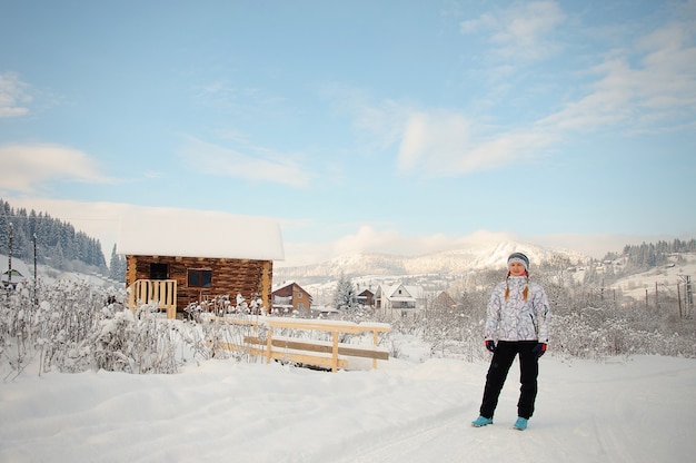 Happy woman on snow in Carpathian mountains