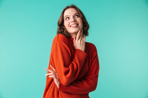 Happy woman standing isolated over blue background