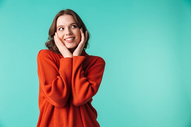 Happy woman standing isolated over blue background