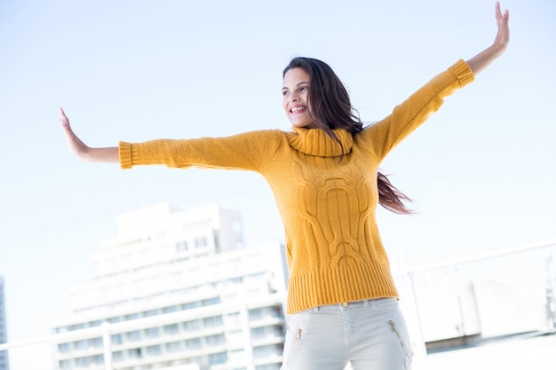 Happy woman standing with arms out 