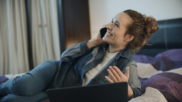 Happy woman talking mobile phone at evening home Smiling woman call phone