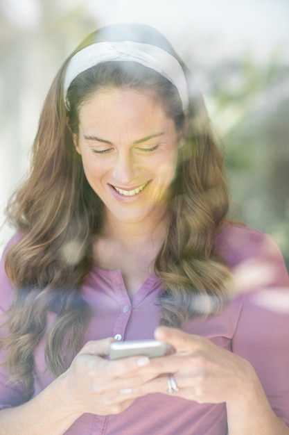 Happy woman text messaging on mobile