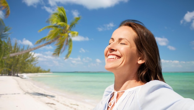 happy woman over tropical beach background