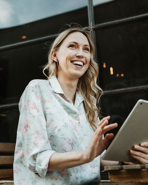 Happy woman using a digital tablet outdoors