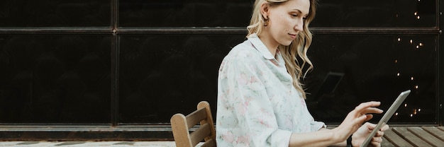 Happy woman using a digital tablet outdoors